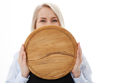 Attractive woman gives empty pizza board for your advertising products isolated on whiteの写真素材