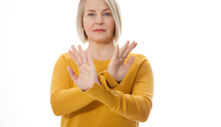 Excited middle aged woman showing the sign of stop, neglect negation and reluctanceの写真素材