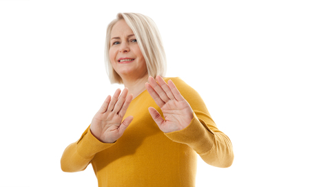Excited middle aged woman showing the sign of stop, neglect negation and reluctanceの写真素材
