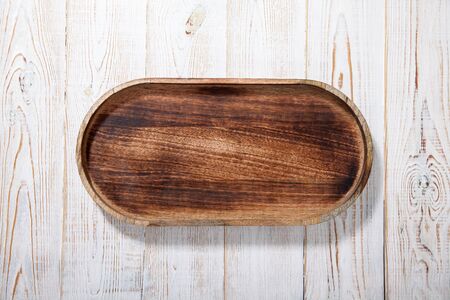 Wooden tray on white wooden table.の写真素材