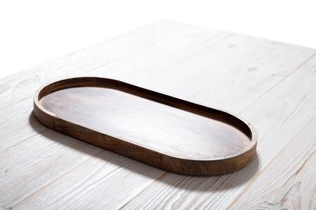 Wooden tray on white wooden table.の写真素材