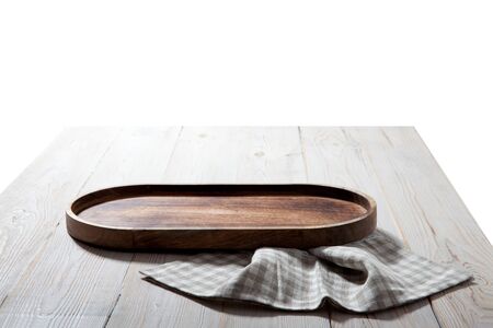 Wooden tray and napkin on white wooden table.の写真素材