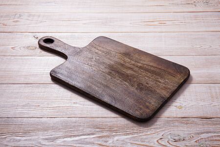 Cutting board on the wooden background. Top view.の写真素材