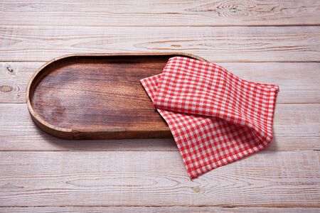Wooden tray and napkin on white wooden table.の写真素材