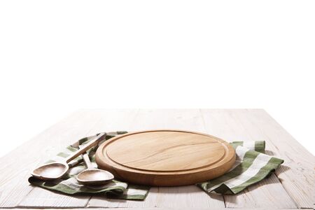 Pizza board, with tablecloth on wooden table and summer background. Top view mockupの写真素材