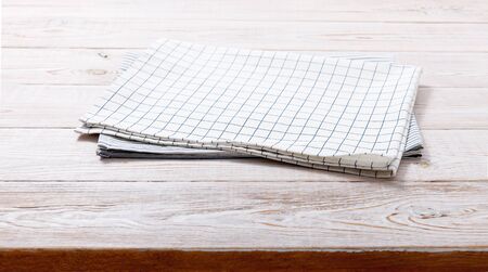 Napkin. Kitchen towel or table cloth on white wooden scene. Mock up for design. Top view.の写真素材