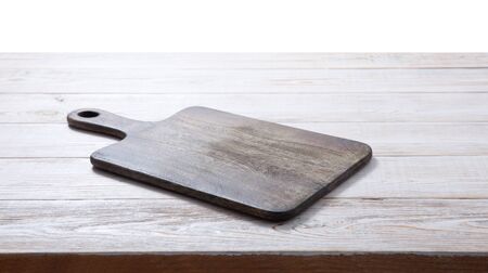 Cutting board on the wooden background. Top view mockup.の写真素材