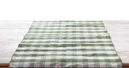 Kitchen towel on empty wooden table on white background. Napkin close up top view mock up for design. .の写真素材
