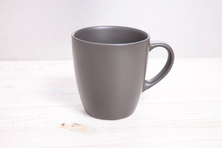 Mug Mockup. Gray Mug on wooden table closeup.の写真素材