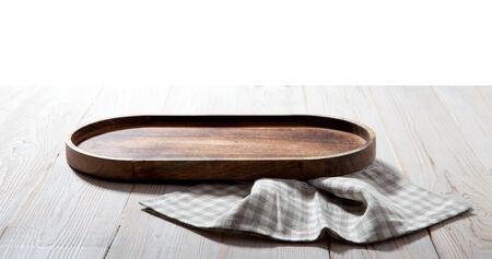 Wooden tray and napkin on white wooden table. Empty tray mock up for design. Top view.の写真素材
