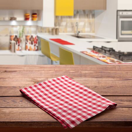 free space on brown desk top and Red checkered tablecloth on empty wooden table. Napkin close up top view mock up for design. Kitchen rustic background.の写真素材