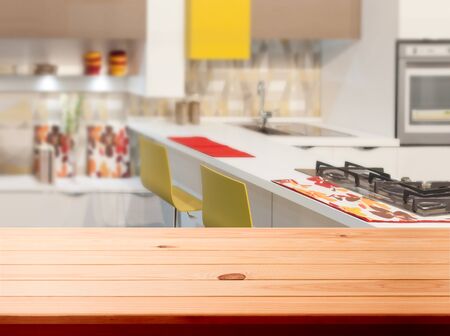 Kitchen, background. Empty textured wooden table and kitchen window shelves blurred backgroundの写真素材