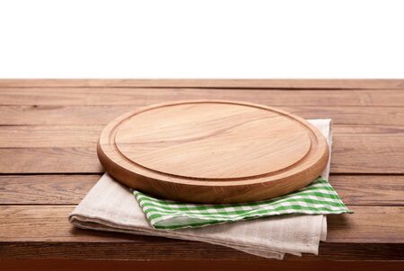 Board for pizza and tablecloth on wooden table isolated. Canvas, dish towels on white background top view mock up. Selective focus.の写真素材