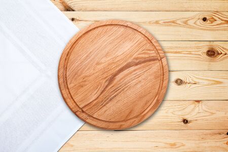 Table cloth and pizza board on vintage wooden table. Top view mockupの素材 [FY310140954862]