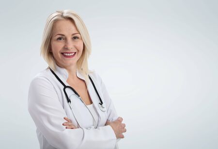 Smiling medical woman doctor. Isolated over white backgroundの写真素材