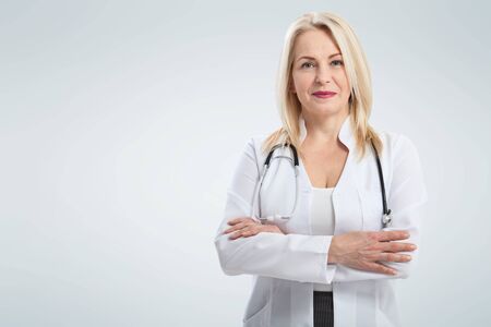 Smiling medical woman doctor. Isolated over white backgroundの写真素材
