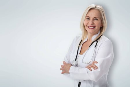 Smiling medical woman doctor. Isolated over white backgroundの写真素材