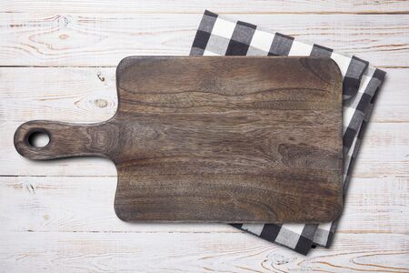 Cutting board and napkin on white wooden table. Empty tray mock up for design. Top view.の写真素材