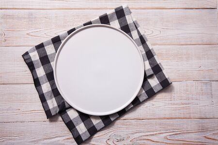 Empty plate and napkin on white wooden table. Empty tray mock up for design. Top view.の写真素材