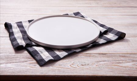 Empty plate and napkin on white wooden table. Empty tray mock up for design. Top view.の写真素材