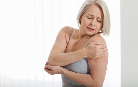 Woman with pain in shoulder. Pain in the human body,health care concept.の写真素材
