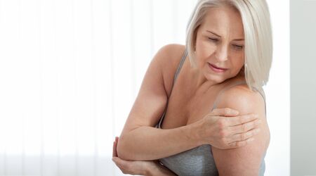 Woman with pain in shoulder. Pain in the human body,health care concept.の写真素材
