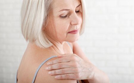 Woman with pain in shoulder. Pain in the human body,health care concept.の写真素材