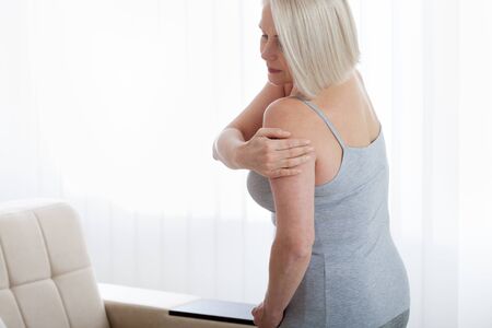 Woman with pain in shoulder. Pain in the human body,health care concept.の写真素材