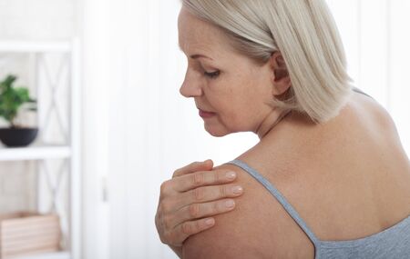 Woman with pain in shoulder. Pain in the human body,health care concept.の写真素材