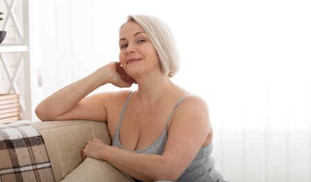 Portrait of beautiful senior woman at home.の写真素材