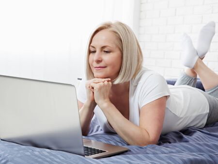 attractive middle aged woman surfing the internetの写真素材