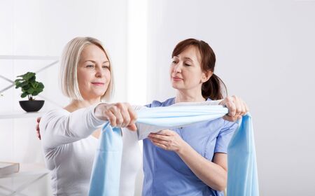 Physiotherapy, sport injury rehabilitation treatment with Resistance Band. Woman having chiropractic back adjustment. Osteopathy, Alternative medicine, pain relief concept.の写真素材