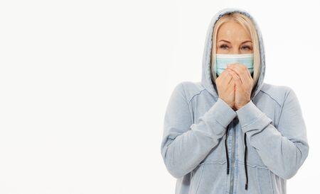 Concept coronavirus, covid-19 respiratory virus with indicating location of the pain. Healthcare, cold, allergy and sick woman blowing her runny nose in paper tissue.の写真素材