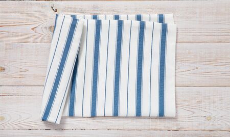 Empty wooden deck table with napkin tablecloth top view mockupの写真素材