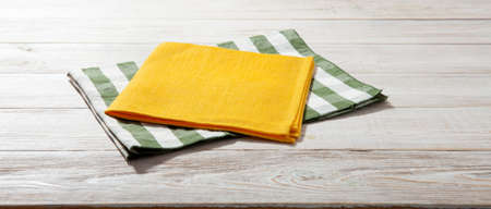 Empty wooden deck table with napkin tableclothの写真素材