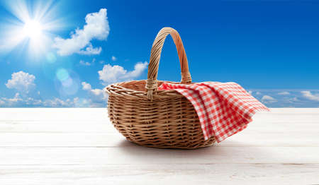 empty basket with red napkin picnic on table placeの写真素材