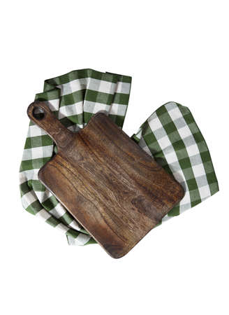 Cutting board over towel on wooden kitchen table. Top viewの写真素材