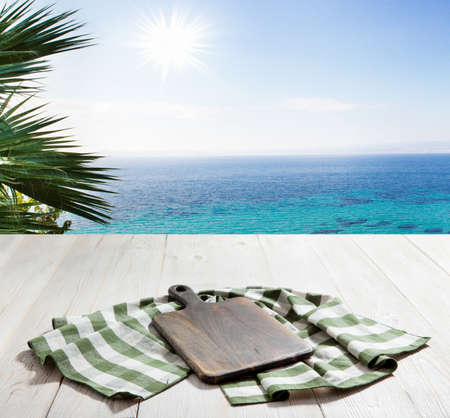 Table cloth on wooden deck table with napkin. Kitchen background.の写真素材