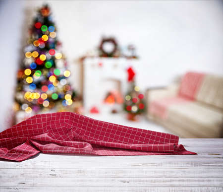 Red napkin on wooden table and Christmas background.の写真素材