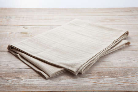 Empty canvas napkin on wooden desk top viewの写真素材