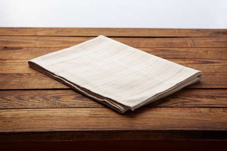 Empty canvas napkin on wooden desk top viewの写真素材