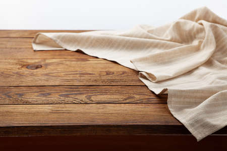 Empty canvas napkin on wooden desk top viewの写真素材