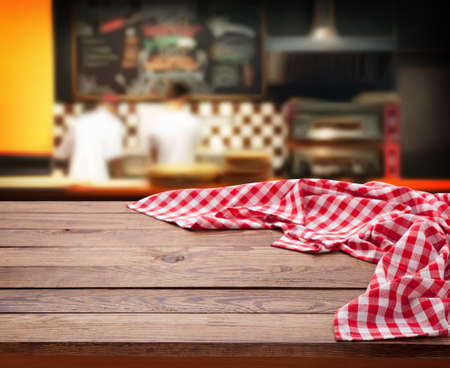 Napkin on wooden desk mockup perspective. Pizzeria interior selective focus.の写真素材
