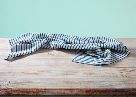 Empty napkin on a wooden table in perspective.