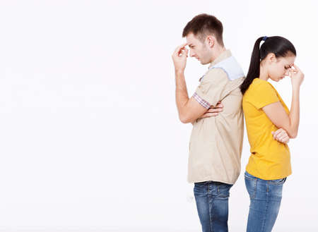 Young couple in summer clothes quarreled and stand with their backs to each otherの写真素材