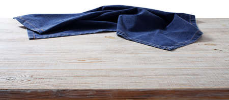 Crumpled linen tablecloth on wooden desk perspective. Selective focus.の写真素材