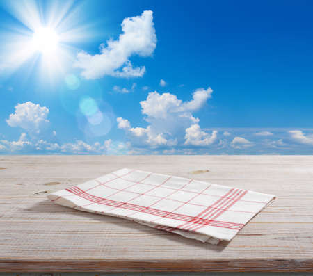 napkin, tablecloth on wooden deck front view mockupの写真素材