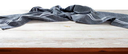 Empty tablecloth on wooden table with napkin top view mockup.の写真素材