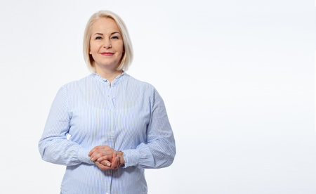 Serious business woman with folded arms on white backgroundの写真素材