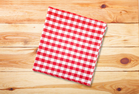 Colorful checkered napkin on wooden background top viewの写真素材
